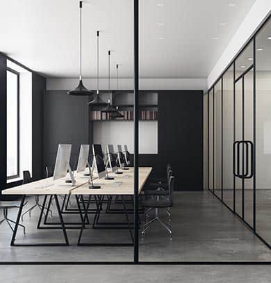 Contemporary office with stylish ceiling design, modern lighting, and glass wall partition.