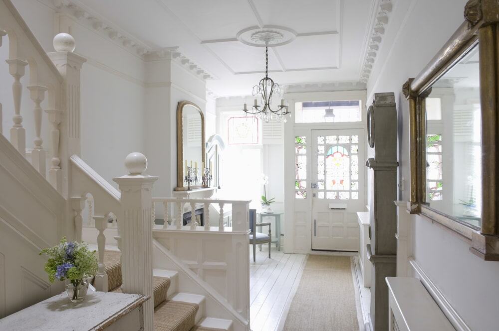 Bright Victorian interior with ornate ceiling mouldings and chandelier, perfect for stylish ceilings.