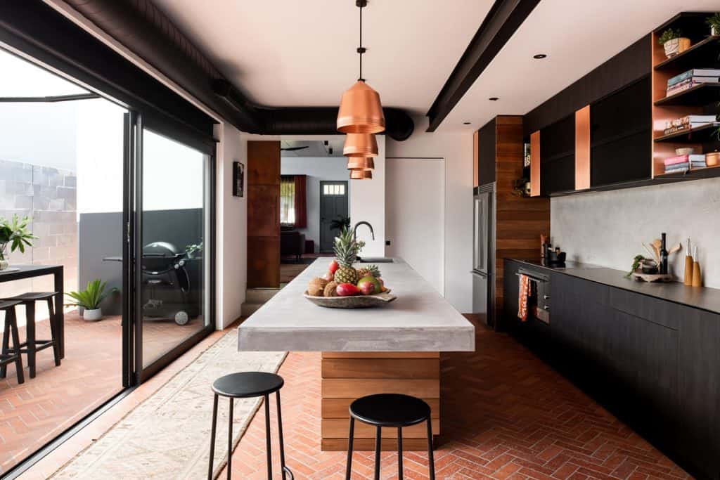 Stylish ceiling with copper pendant lights enhances kitchen aesthetics.