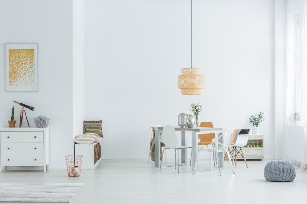 Bright interior with modern ceiling design in a minimalist living and dining space.