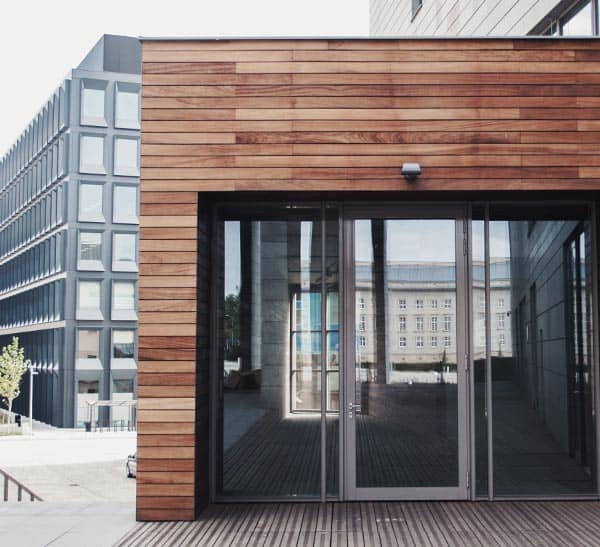 Modern interior ceiling design with wooden accents and sleek glass doors.