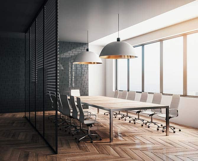 Bright, stylish conference room with sleek ceiling lights and large windows for natural light.