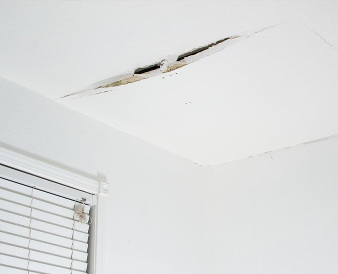 Ceiling with hole and damage, requiring repair by professional ceiling specialists in AU.